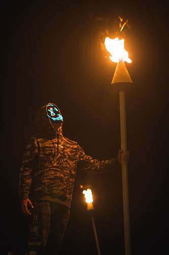 united states person holding torch while walking at night hilo